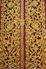 Ancient art pattern on the wooden door in Thai temple