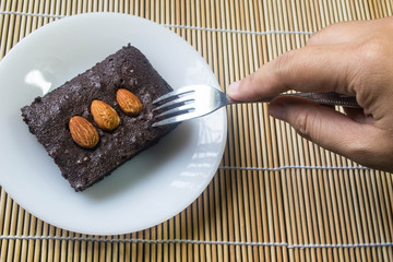 Cakes, brownies, sprinkle almonds are tasting.