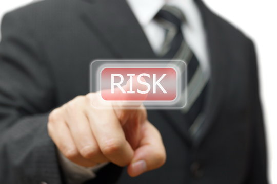 Businessman pressing  risk icon on virtual screen