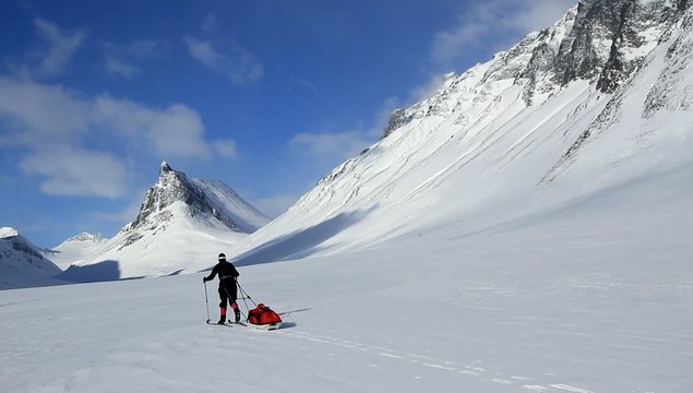 Cross country skier with pulka (sled) in Swedish Lapland.