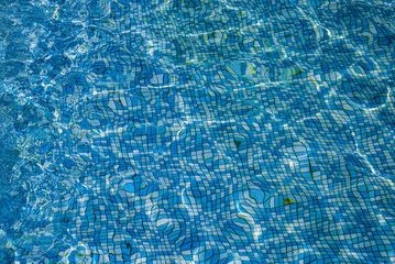 Water with patches of sunlight on  background of mosaic