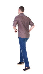 Fototapeta premium Back view of running man in brown shirt.