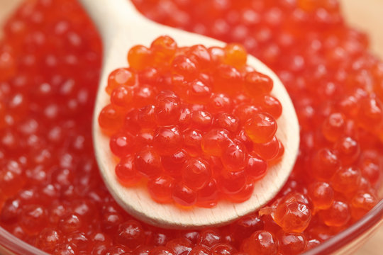 Red caviar on a wooden spoon