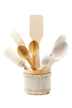 Wooden kitchen utensils on white background.