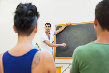 Students at school with teacher at blackboard