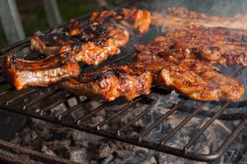 Closeup of delicious pork ribs on barbeque grill.
