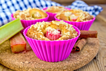 Cupcakes with rhubarb in tins on board