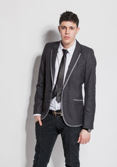 Fototapeta premium sexy latin man in black suit posing against white background