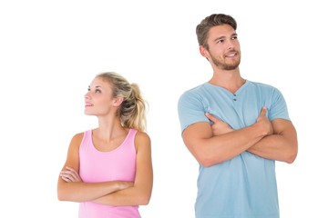 Young couple posing with arms crossed