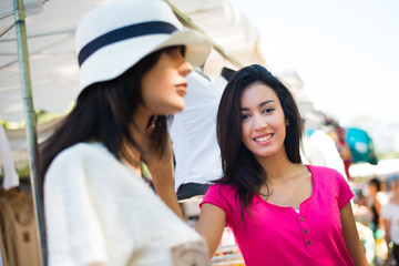 cheerful young woman shopping in farmer's market clothes