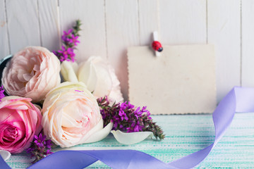 Postcard with fresh flowers  on wooden background