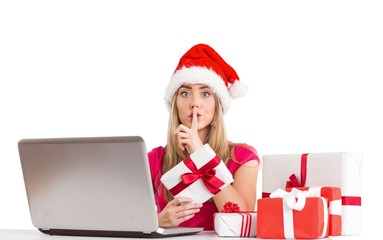 Festive blonde shopping online with laptop