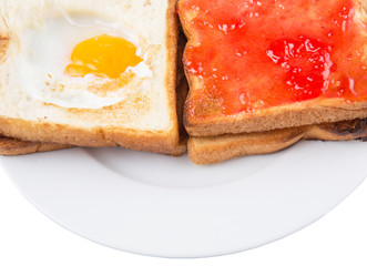 Bread toast with fried egg and strawberry jam