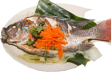 A Steamed Tilapia fish garnish with vegetables