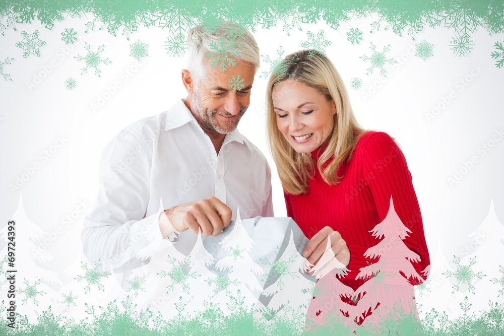Poster composite image of smiling couple looking into shopping bag