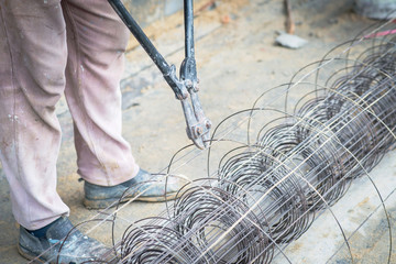 Fototapeta na wymiar Worker cut steel with iron scissors in Construction