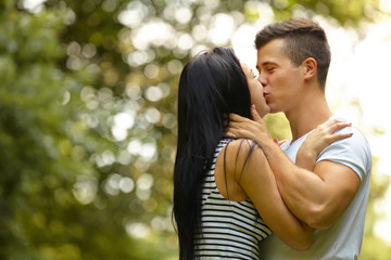 Fototapeta premium Kissing couple. Portrait of young caucasian couple kissing