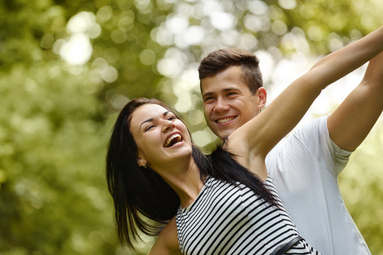 Young Happy Couple Hugging and Laughing.