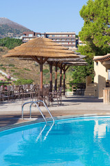 swimming pool and bar with umbrellas