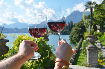 Wineglasses against lake Como, Italy