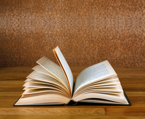 Old open book on grunge wooden table