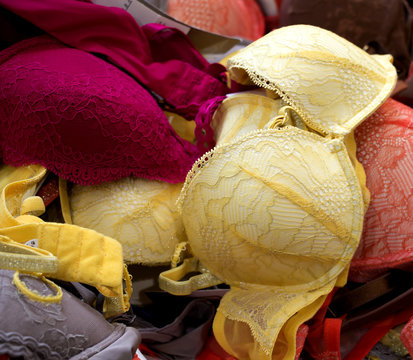 Woman Brassieres pile in box at discount store.