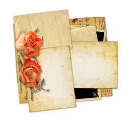 Pile of old photos and letters with bouquet of dried roses on wh