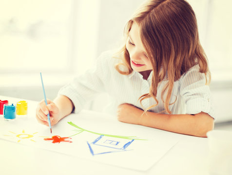 little girl painting picture