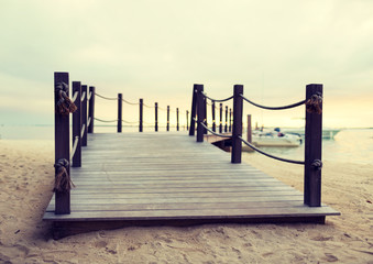 close up of pier on tropical beach