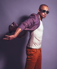 Young handsome man in trendy glasses, purple jacket, white under