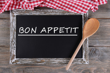 Bon appetit written on chalkboard, close-up