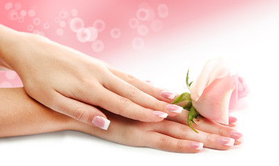 Young woman hands with elegance manicure on bright background