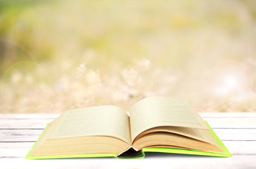 Open book on table outdoors