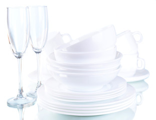 Set of white dishes on table on light background