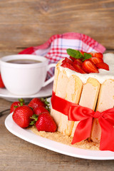 Tasty cake Charlotte with fresh strawberries on wooden table