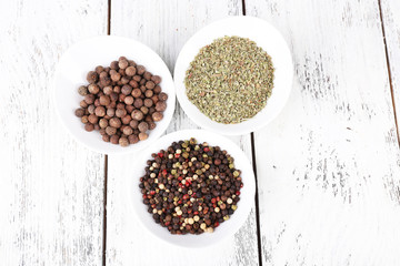 Spice in round bowls on wooden background