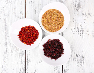 Spice in round bowls on wooden background