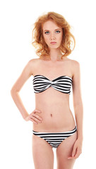 Fototapeta premium Young woman with slim body in swimsuit isolated on white
