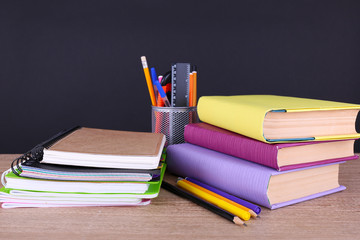 School supplies on table on dark background