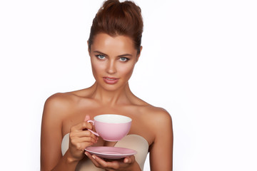 Young beautiful woman drink tea or coffee on a white background