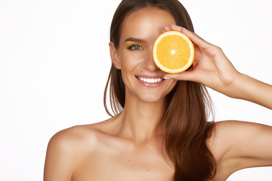Beautiful woman holding orange healthy eating organic food diet
