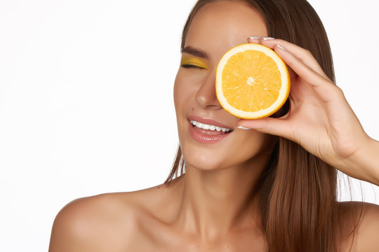 Beautiful woman holding orange healthy eating organic food diet