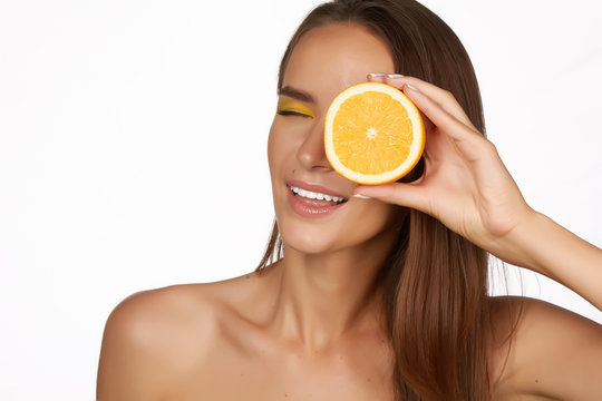 Beautiful woman holding orange  healthy eating organic food diet