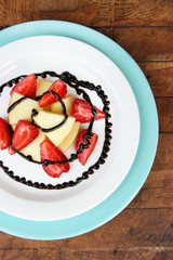fresh tasty fruit salad on wooden table