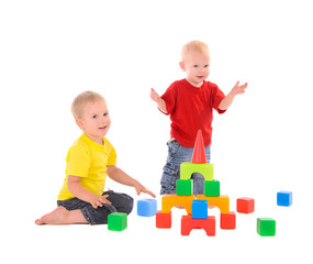 two brothers builds toy building of colored cubes