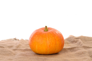 orange ripe pumpkin on linen cloth background