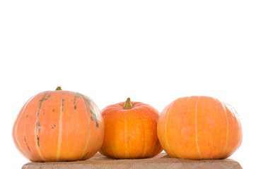 three orange ripe pumpkins