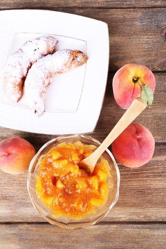 tasty peach jam with fresh peaches and croissants
