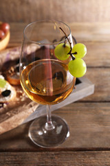 beautiful still life with wine, cheese and ripe grape