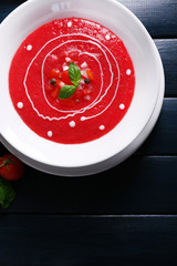 Gazpacho soup on color wooden background